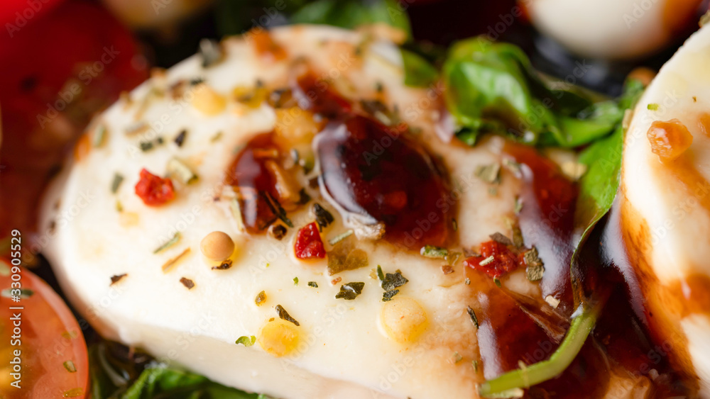 Mozzarella and cherry tomato, basil and balsamic vinegar salad. Italian cooking. Macro