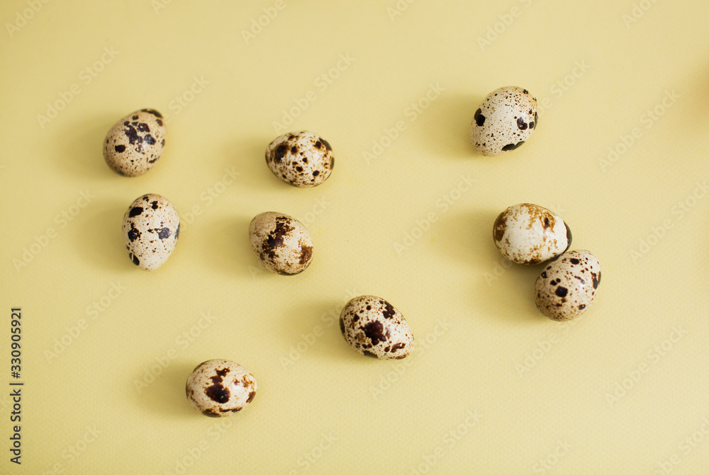 Quail eggs on a yellow background