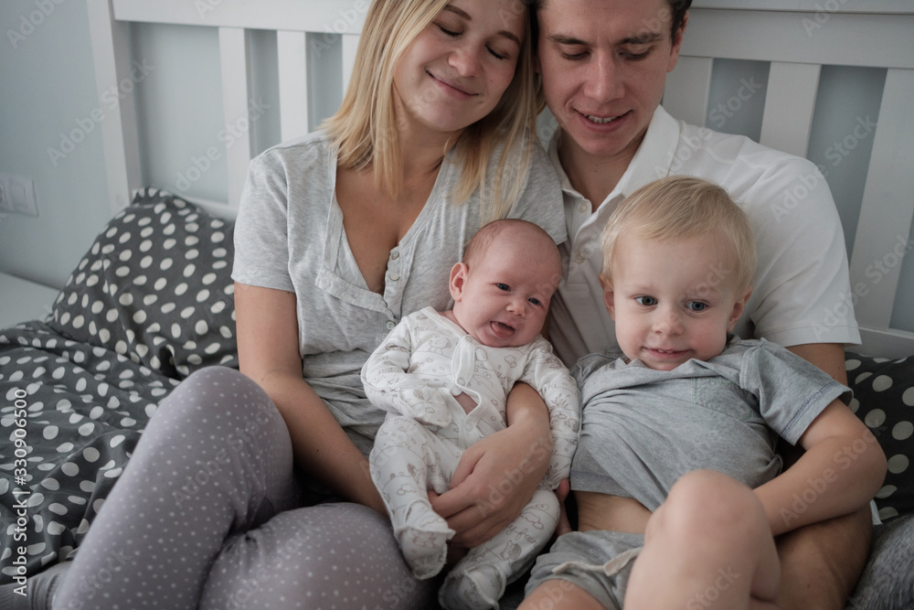 Family portrait: dad, mom, two sons.