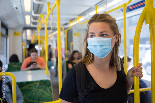 Young Woman Wearing a Face Mask Riding the Melbourne Tram