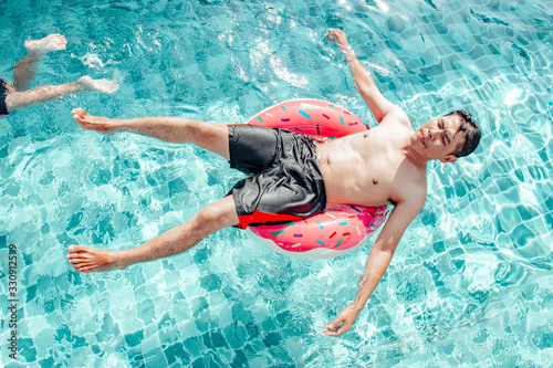 Holiday, vacation concept, Father and son swimming in the pool during the day. Very happy and fun.