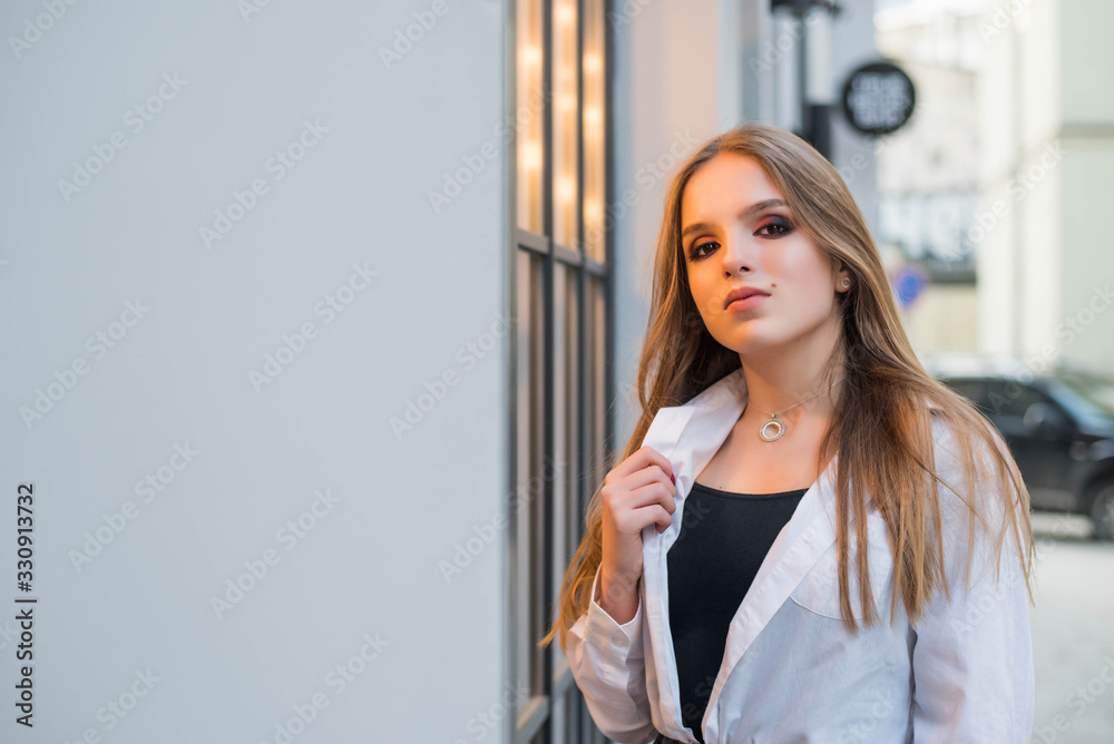 Headshot Portrait of teenage ginger girl looking at camera. City cafe light background. Bright makeup. Headshot Portrait of teenage ginger girl looking at camera. City cafe light background. Bright makeup.