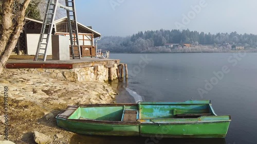 Wide angle dolly in drone shot of peddle boats, boat houses, and Fisheries in Smartinsko Lake and surrounding landscapes during the day photo