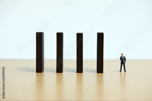 Business strategy conceptual photo - Miniature of businessman stands at the edge of wooden bridge staircase