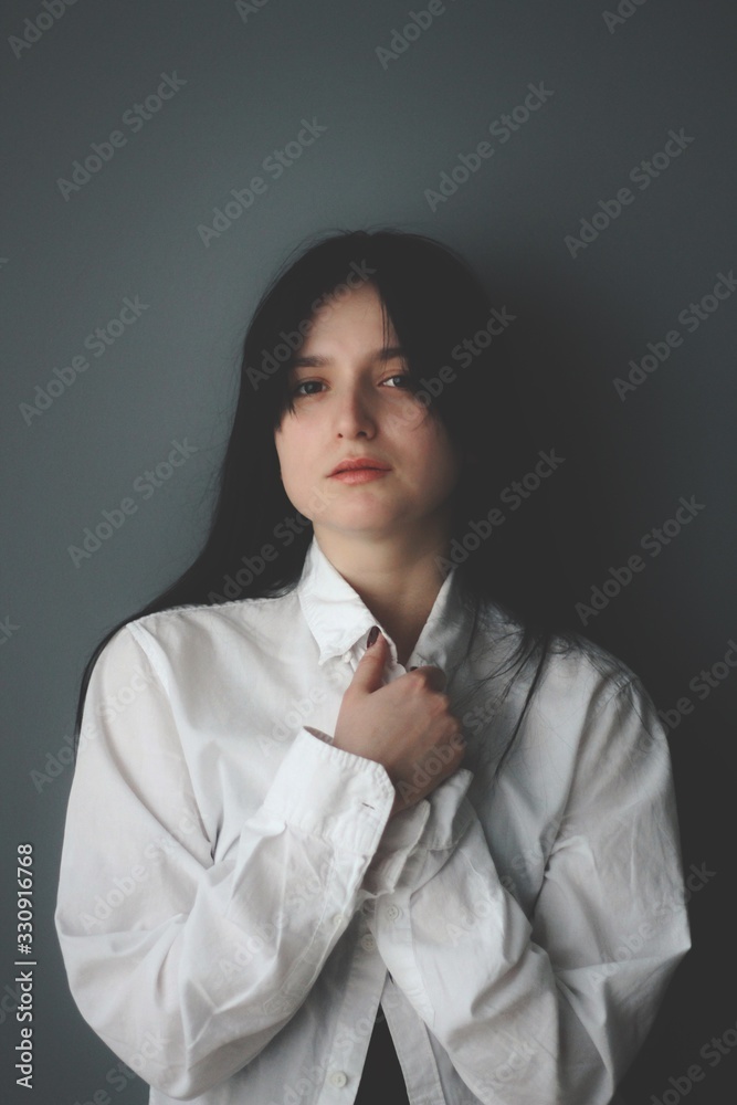 Attractive caucasian brunette girl at home, emotional portrait