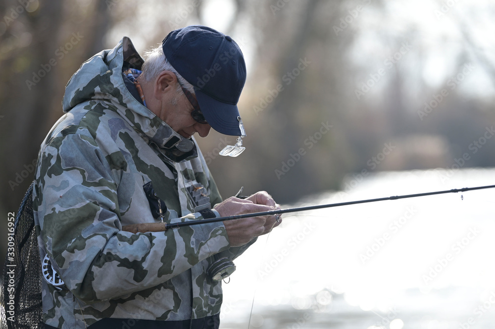 fly fisherman in river in winter fly fisherman in river in winter