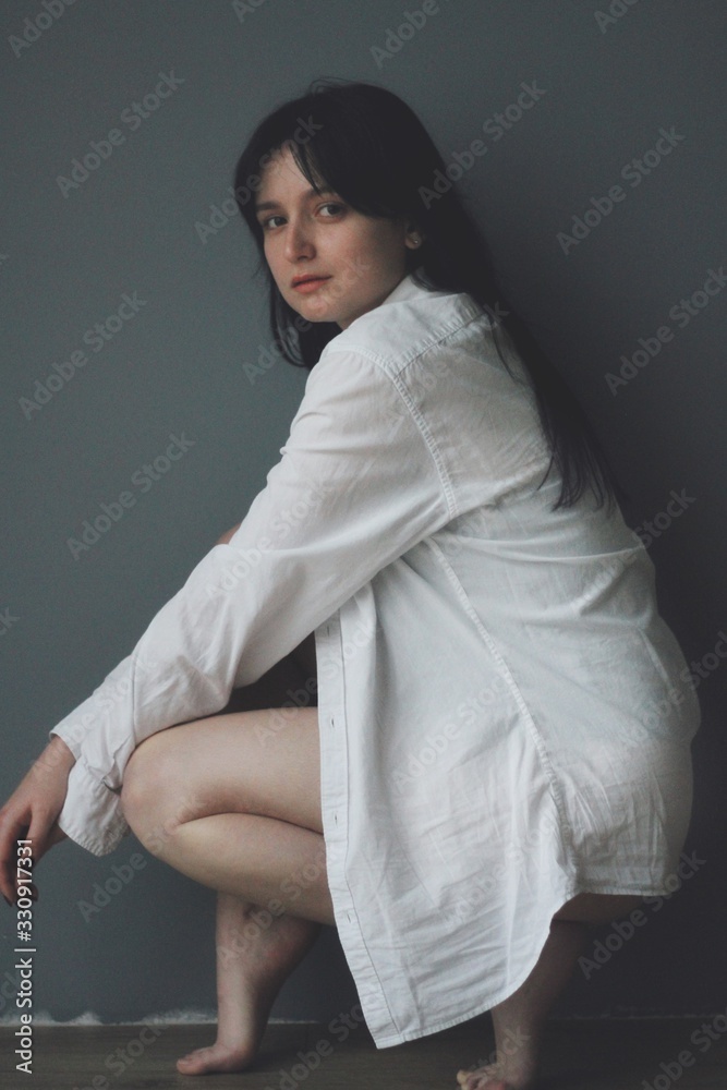 Attractive caucasian brunette girl at home, emotional portrait