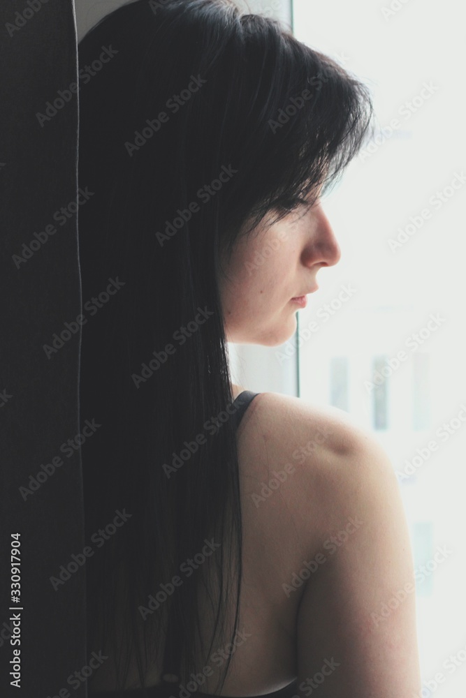 Attractive caucasian brunette girl at home, emotional portrait