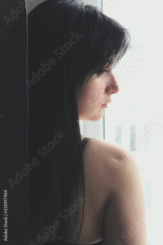 Attractive caucasian brunette girl at home, emotional portrait