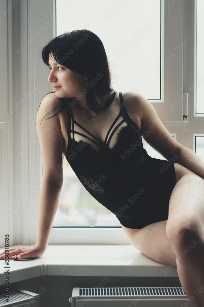 Attractive caucasian brunette girl at home, emotional portrait