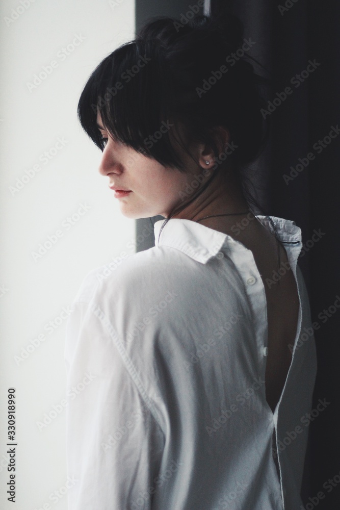 Attractive caucasian brunette girl at home, emotional portrait