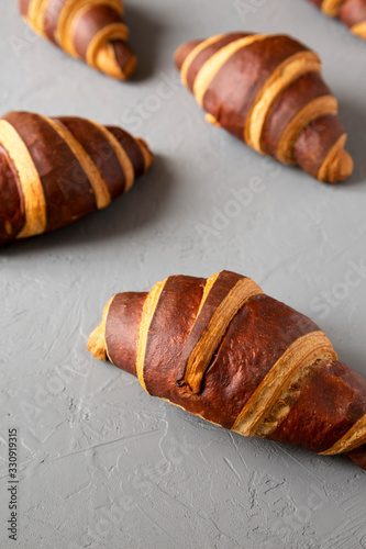 Homemade Croissants with Chocolate on gray background, low angle view.