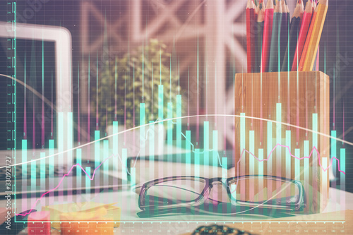 Financial chart hologram with glasses on the table background. Concept of business. Double exposure.