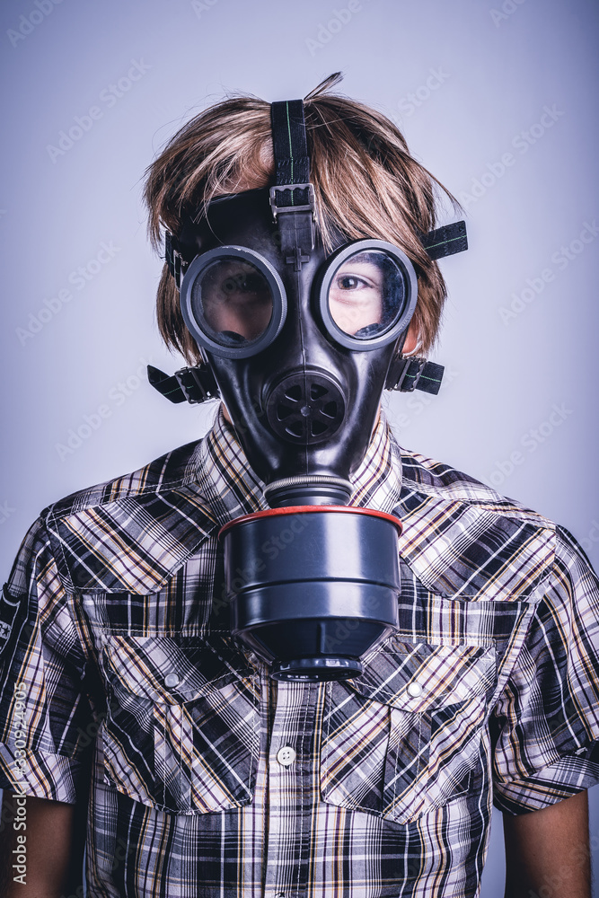 Little boy wearing a protective mask for nuclear bacteriological chemical risk Little boy wearing a protective mask for nuclear bacteriological chemical risk