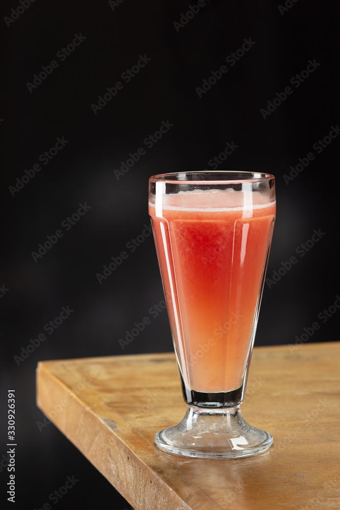 Fresh grapefruit juice in glass. Macro. Selective focus Fresh grapefruit juice in glass. Macro. Selective focus