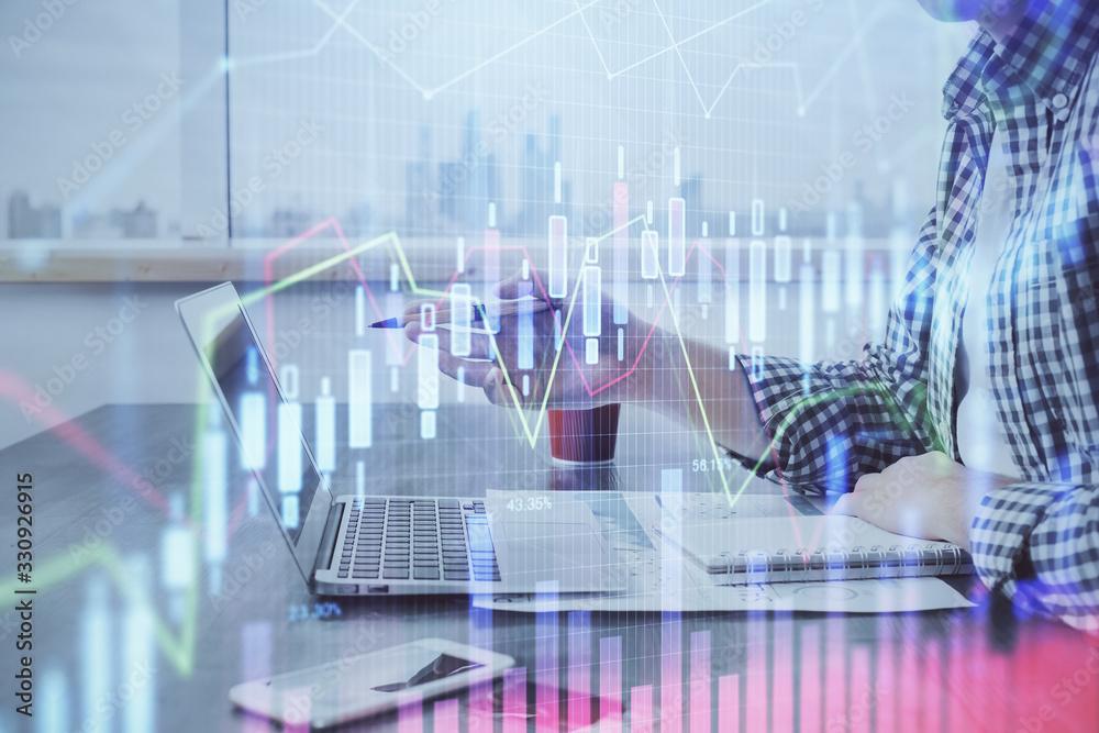 Double exposure of stock market chart with man working on computer on background. Concept of financial analysis. Double exposure of stock market chart with man working on computer on background. Concept of financial analysis.