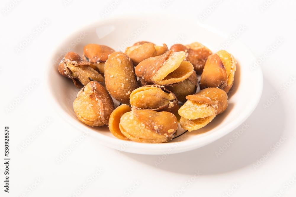 Homemade roasted broad beans are isolated in a white background Homemade roasted broad beans are isolated in a white background