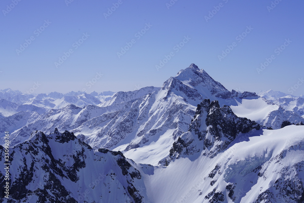 Snow-covered mountains and blue sky