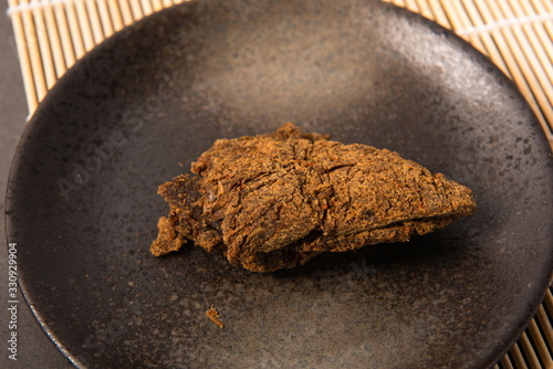 Homemade jerky on a black plate photo