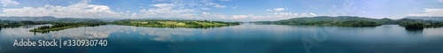 Beautiful lake and mountain scenery; blue sky and white clouds reflecting on the water