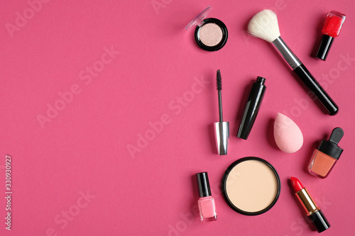 Makeup decorative cosmetics and tools on pink background. Flat lay, top view, copy space. Beauty and fashion concept.