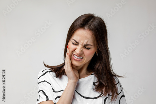 Bild auf Leinwand young sad woman suffering from tooth pain, caries