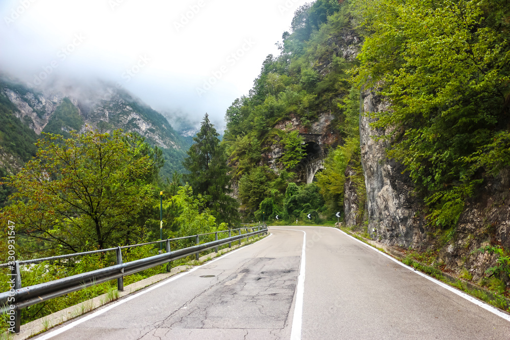 Mountain road in Belluno province. Cloudy day in italian mountains. Mountain road in Belluno province. Cloudy day in italian mountains.