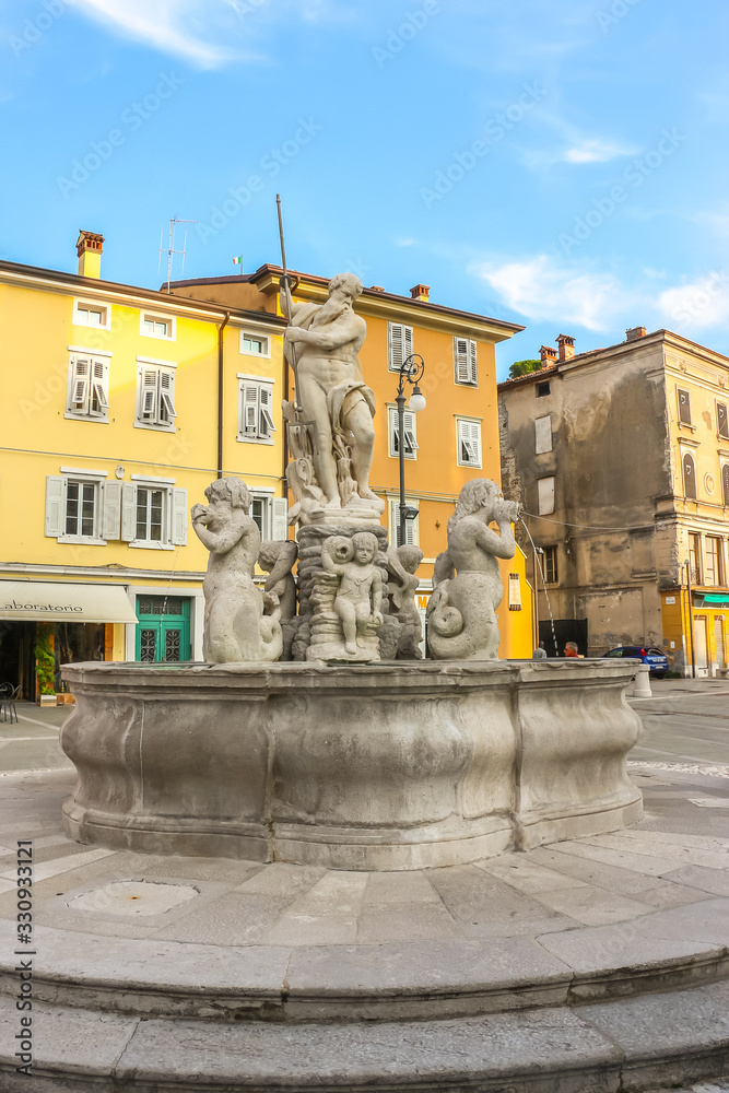 Gorizia, Italy. Beautiful view of Fountain of Neptune (Fontana del Nettuno) at Piazza della Vittoria.