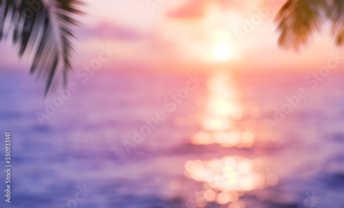 Blurred background of tropical sunset with sun track over sea