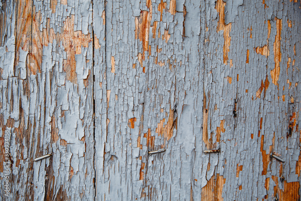 Old wooden wall with remnants of paint. Background done in retro style Old wooden wall with remnants of paint. Background done in retro style