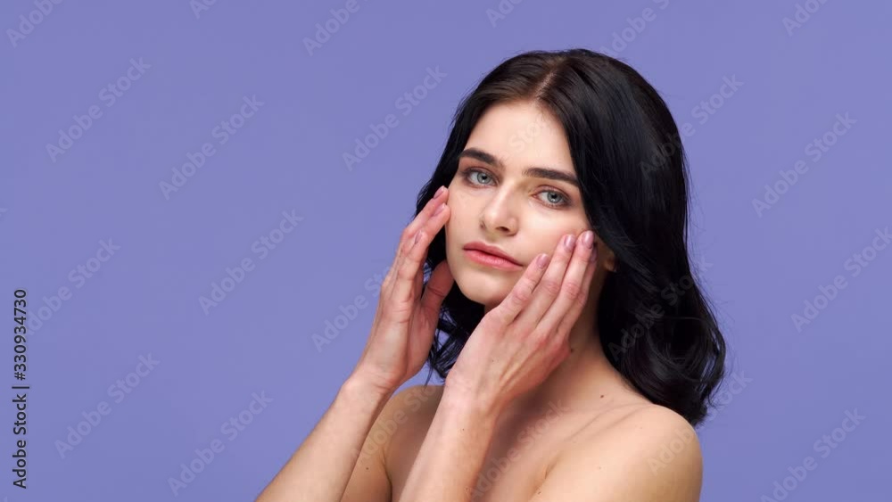 Studio portrait of young and beautiful brunette woman over purple background. Skin care, health, makeup and cosmetics. Studio portrait of young and beautiful brunette woman over purple background. Skin care, health, makeup and cosmetics.