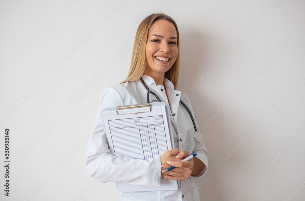 Confident doctor standing with document. Confident young woman doctor. Intern Doctor Young pretty woman in white clothes with a stethoscope posing and smiling