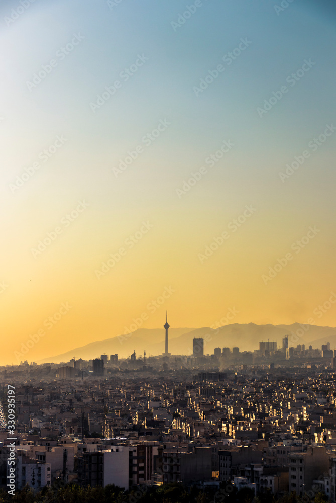 Obraz premium Beautiful sunset over Tehran skyline with Milad tower in the Frame and amazing colorful sky.