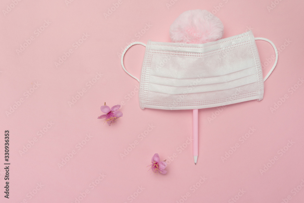 white health protective mask from corona virus or covid-19 disease with natural pink flower and fluffy cute pen white health protective mask from corona virus or covid-19 disease with natural pink flower and fluffy cute pen