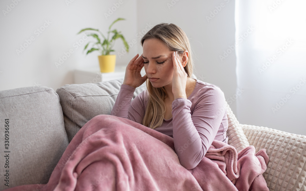 Portrait of tired young woman suffering from headache Portrait of tired young woman suffering from headache