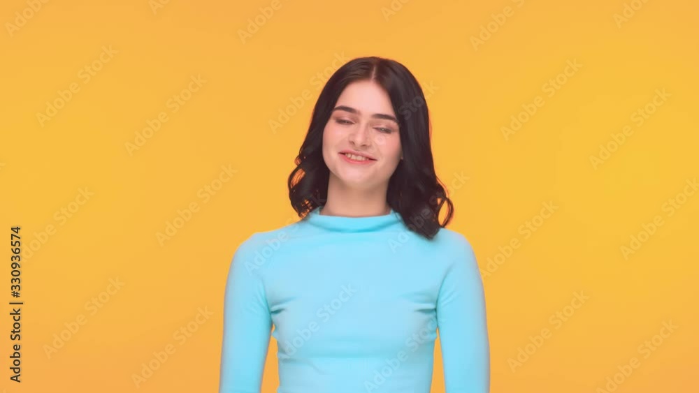 Studio portrait of young and expressive teenage girl over yellow background. Studio portrait of young and expressive teenage girl over yellow background.