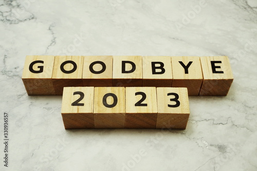 Goodbye 2023 alphabet letters on marble background