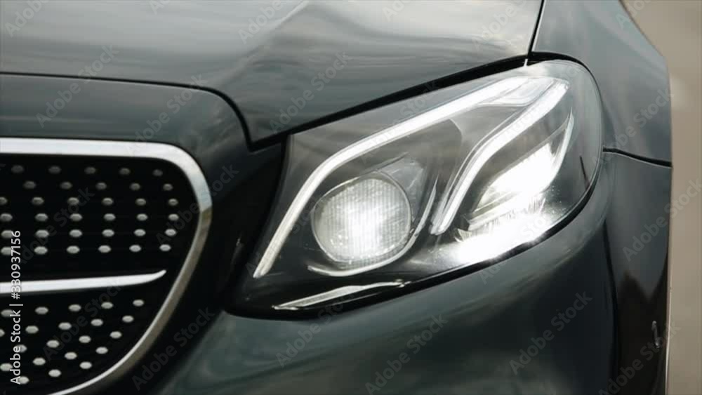 black modern car closeup. concept of fast sport car. car headlights black modern car closeup. concept of fast sport car. car headlights