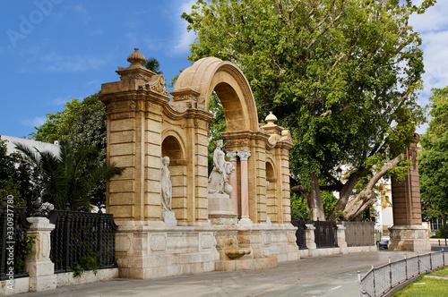 Maria Luisa's Palace with an arch and fountain. Seville, Spain. Architectural details, stone facade.
