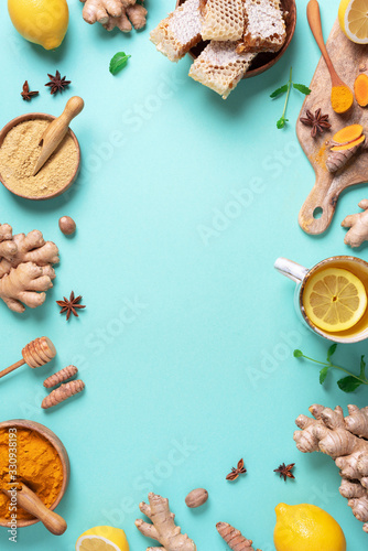 Medical care concept. Cold, flu treatment. Ginger, lemon, honey, pills, drugs, supplements, thermometer on blue background. Natural alternative holistic approach. Top view, copy space