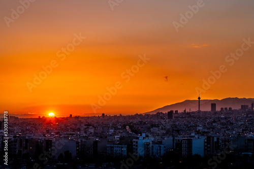 Beautiful sunset over Tehran skyline with Milad tower in the Frame and amazing colorful sky.