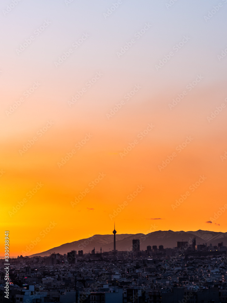 Beautiful sunset over Tehran skyline with Milad tower in the Frame and amazing colorful sky. Beautiful sunset over Tehran skyline with Milad tower in the Frame and amazing colorful sky.