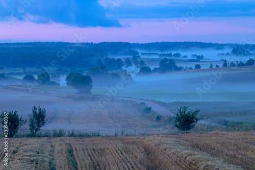 Evening fog over the fields. Agricultural landscape in eastern Lithuania.