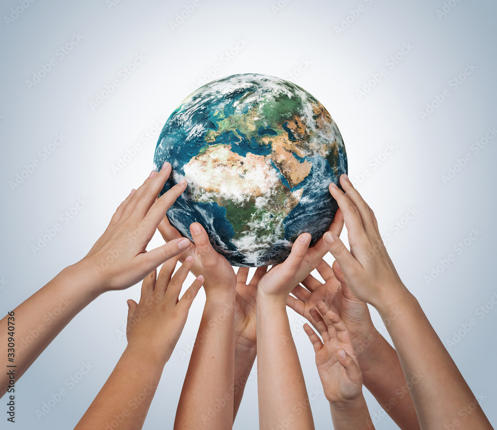 Many children hands holding planet earth isolated on blue background with copy space - obrazy, fototapety, plakaty 