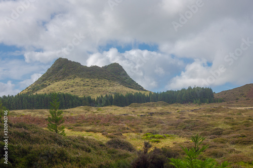 Double Hill over fields. Terceira island in Azores with blue sky and clouds.