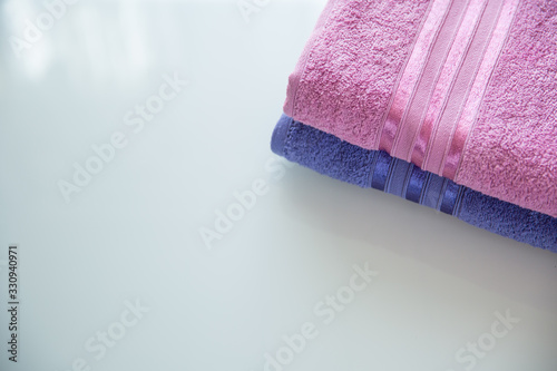folded towels on white background top view