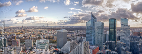Aerial panoramic drone shot of La Defense skycraper in Paris with clouds and sunset photo