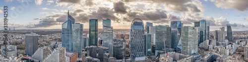 Aerial panoramic drone shot of La Defense skycraper in Paris with clouds and sunset photo