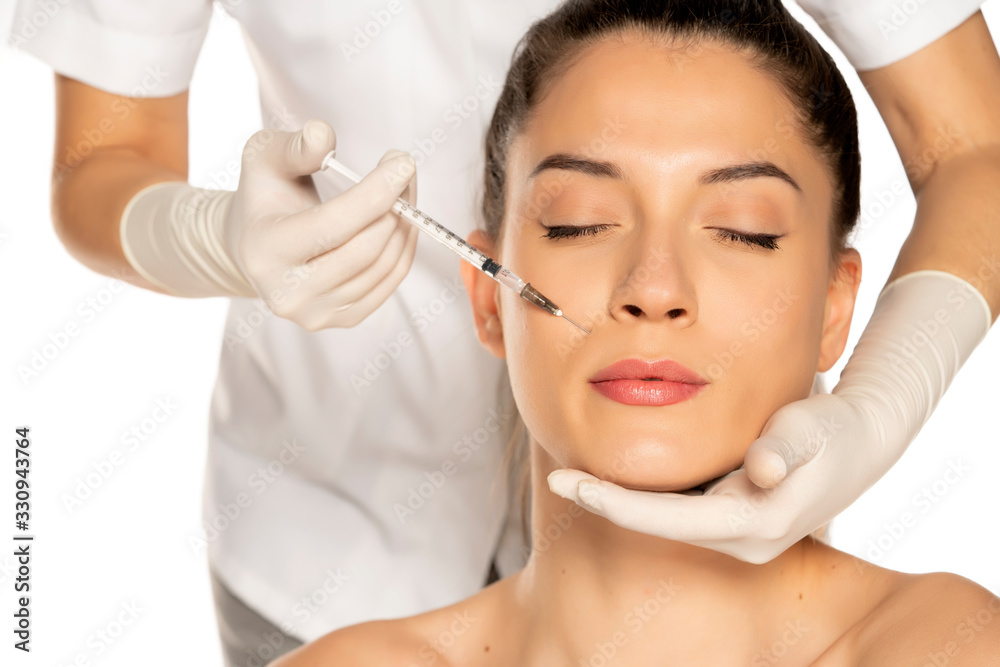 beautiful woman on a face filler injection procedure beautiful woman on a face filler injection procedure