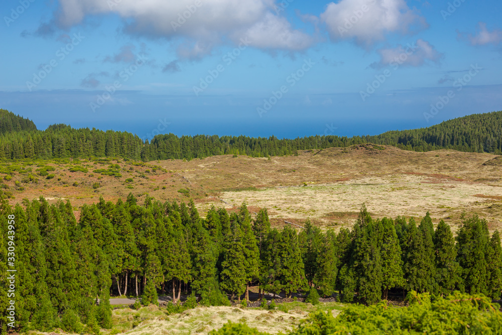 Hills over fields. Terceira island in Azores with blue sky and clouds. Hills over fields. Terceira island in Azores with blue sky and clouds.